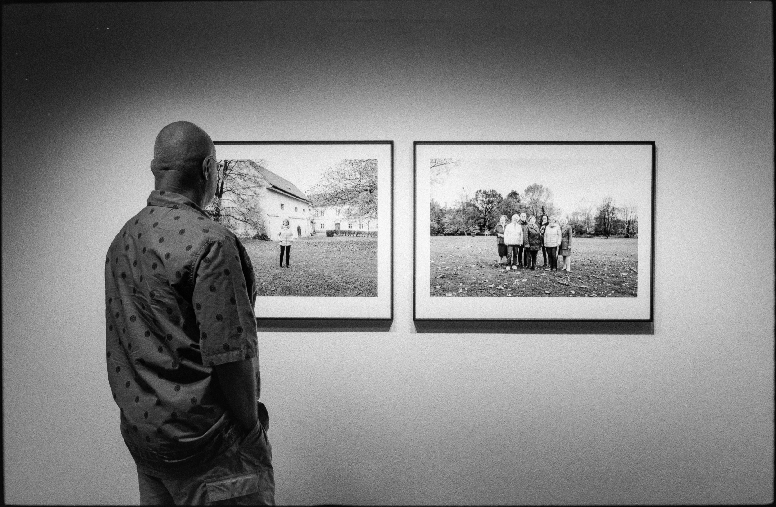 Visitor at an exhibition looking at two photos
