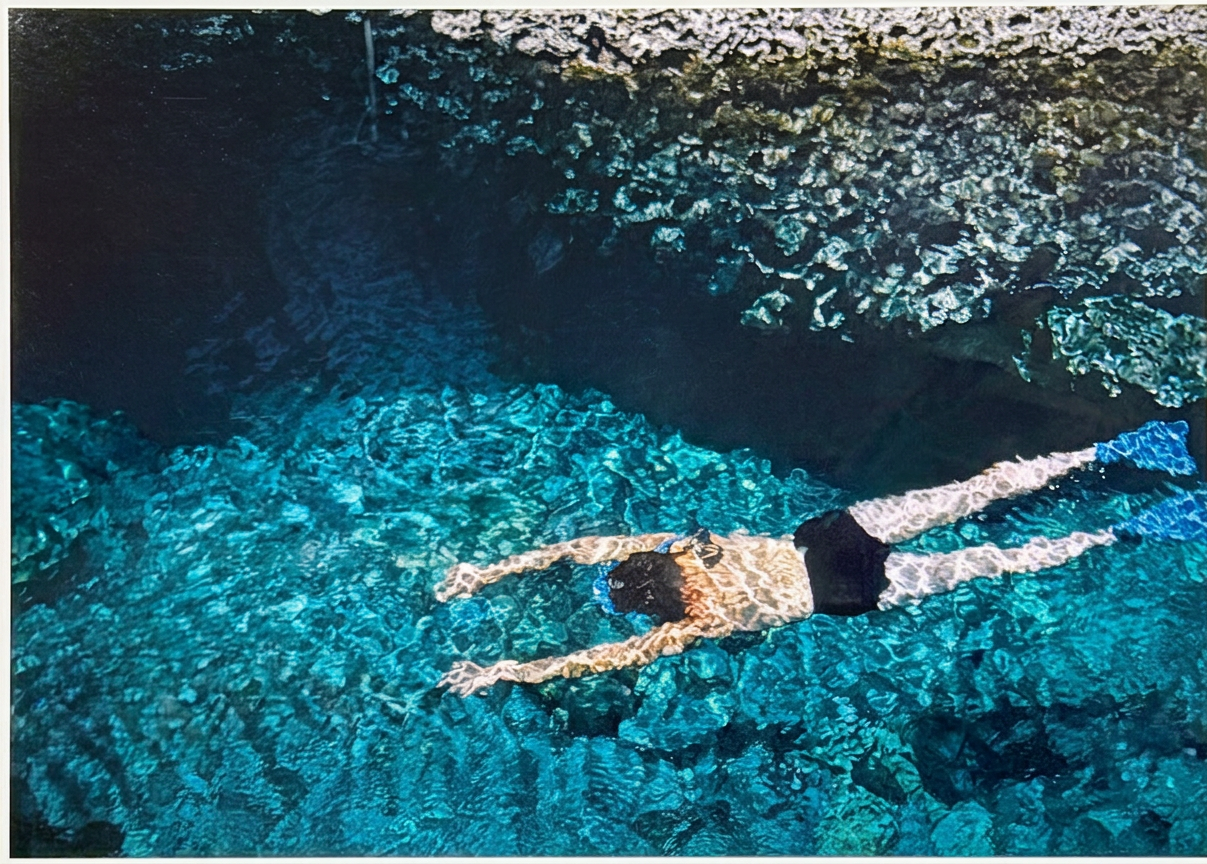 Swimmer diving in turquoise sea in Greece